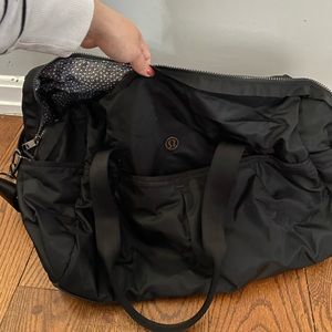 Black lululemon duffel bag and shoe sleeve